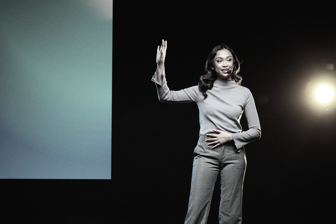 Woman Giving a Talk in Public on Stage